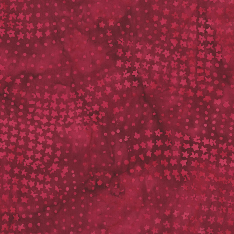 Mottled red fabric with a pattern of scattered dots and stars.