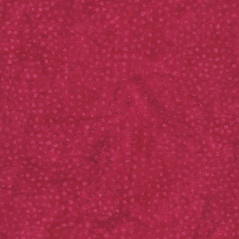 Mottled red fabric with a tonal pattern of scattered dots.