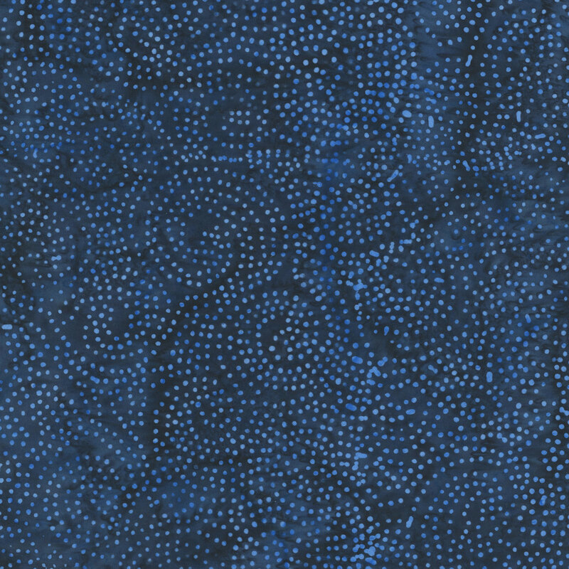 Mottled navy blue batik fabric with a circular pattern of scattered dots.