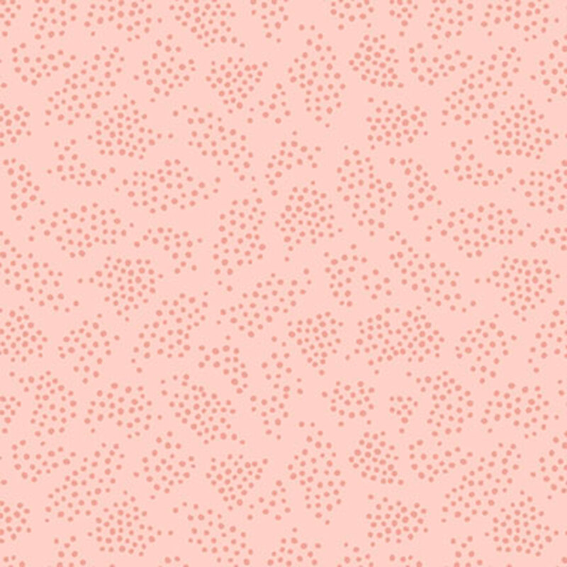 Pastel pink fabric with tonal patches of scattered dots.