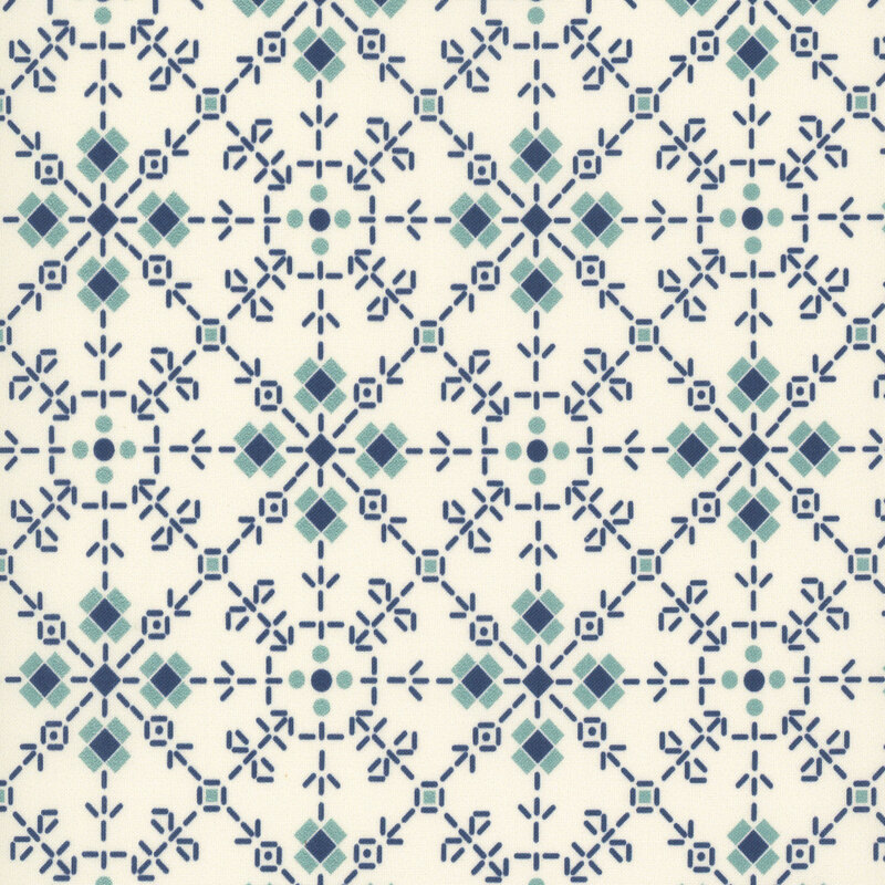 Swatch of cream fabric with a denim and raindrop blue ornamental tiled pattern of dashes, dots, and squares.