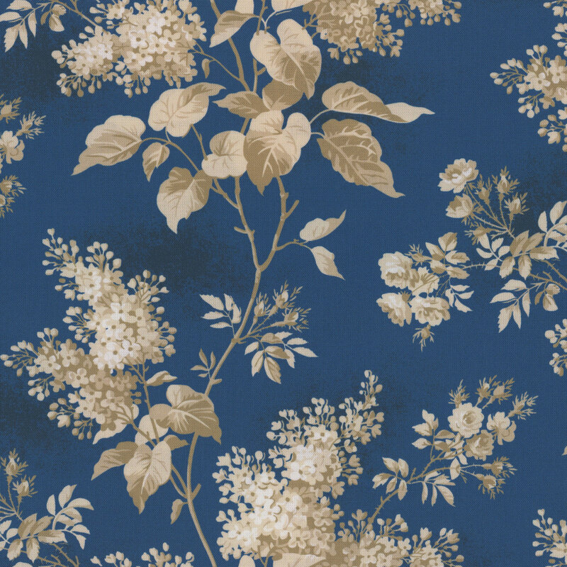 Textured dark navy fabric featuring lilac blossoms and foliage in hues of taupe, cream, and white.
