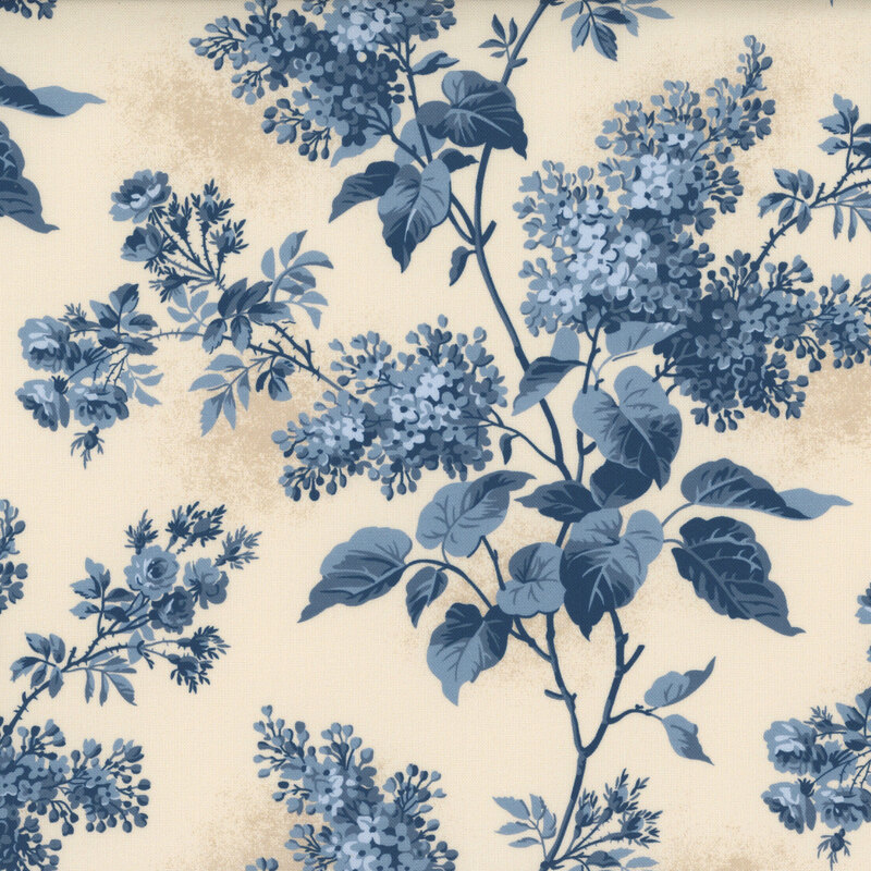 Textured cream fabric featuring lilac blossoms and foliage in varying shades of blue.