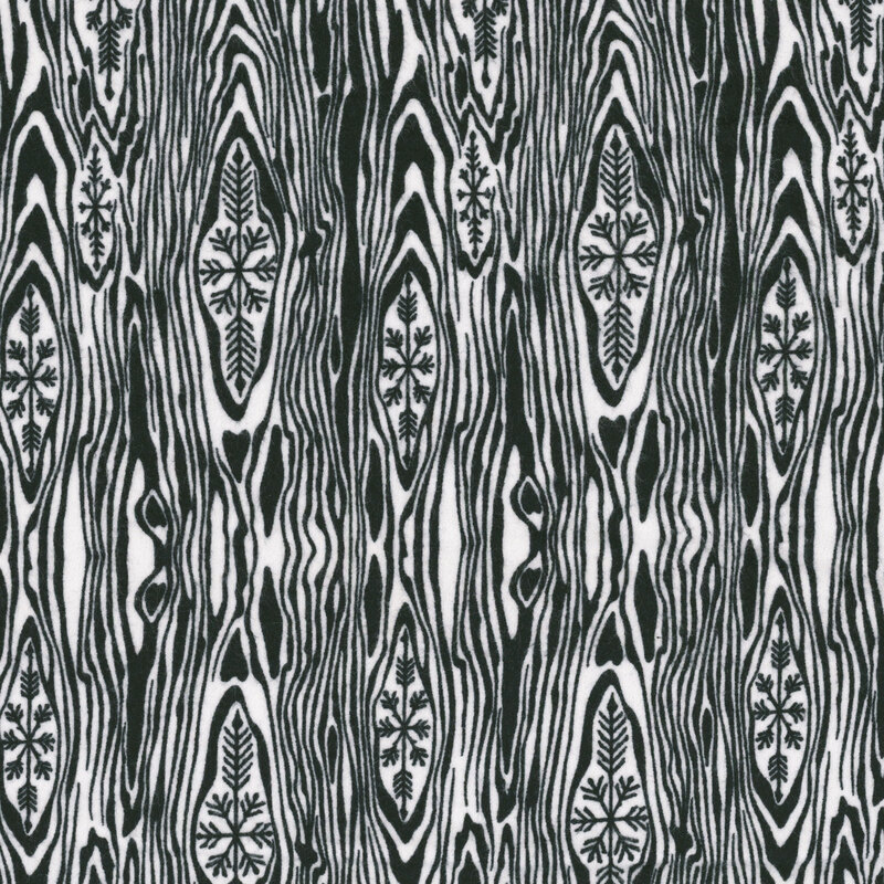 an 8x8 swatch of black and white wood grain flannel fabric featuring snowflake motifs.