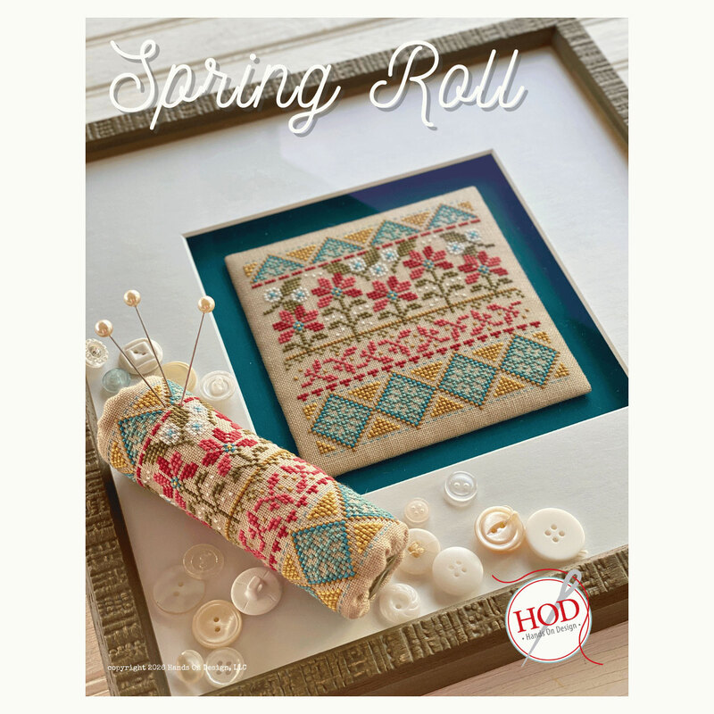 Front of the Spring Roll pattern showing the completed cross stitch design framed as a wall hanging and as a rolled pincushion.