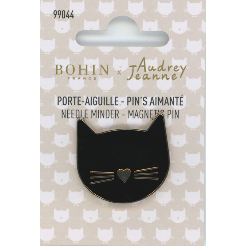 Black cat-shaped magnetic needle minder on a card with a repeating cat face pattern.