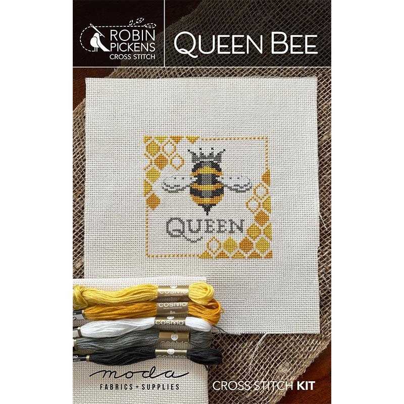Cross stitch kit design featuring a bee and the word QUEEN on a white fabric background.