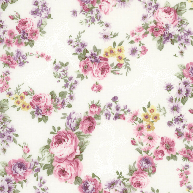 Cream fabric with wreaths of florals, cream colored bows, and purple-pink roses.