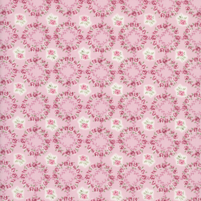 Soft pink fabric layered with a grid of mauve-pink rose wreaths and roses.