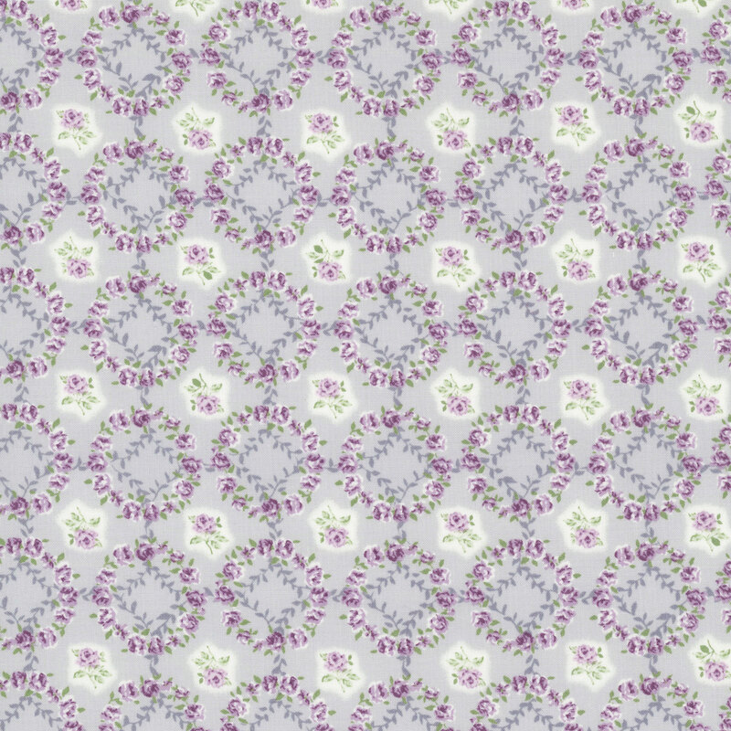 Blue-gray fabric layered with a grid of soft purple rose wreaths and roses.