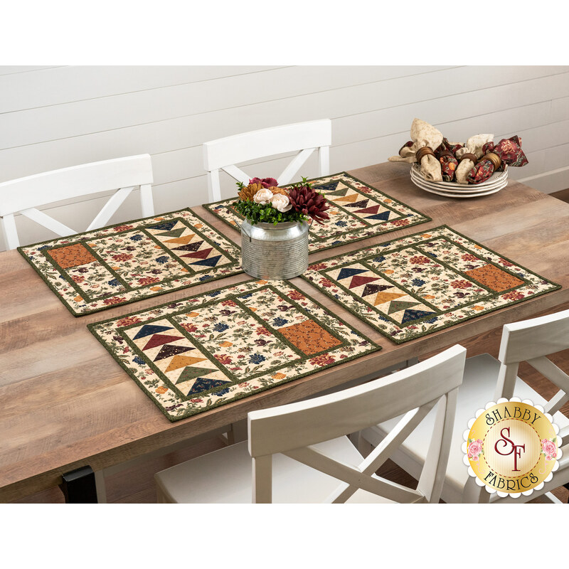 The completed Quail Run placemats, set on a wooden table with rustic décor. 
