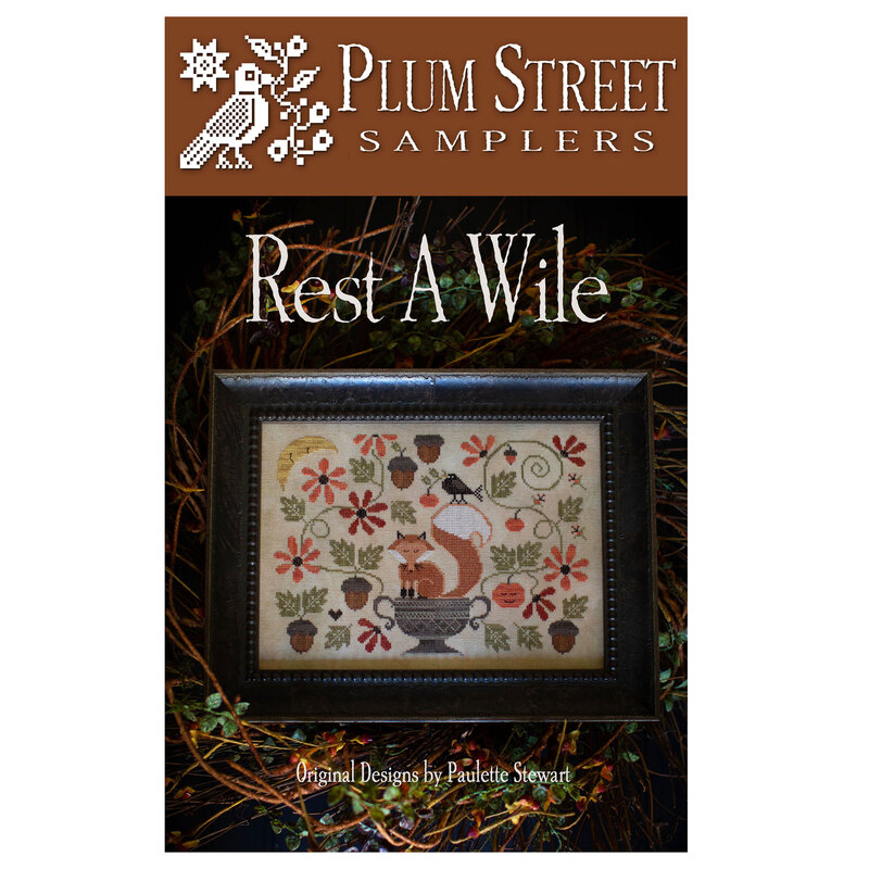 Cross-stitch pattern cover titled Rest A Wile, featuring a sleepy fox and crow surrounded by flora and acorns.