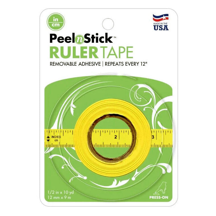 A roll of yellow ruler tape in it's green Peel n Stick packaging.
