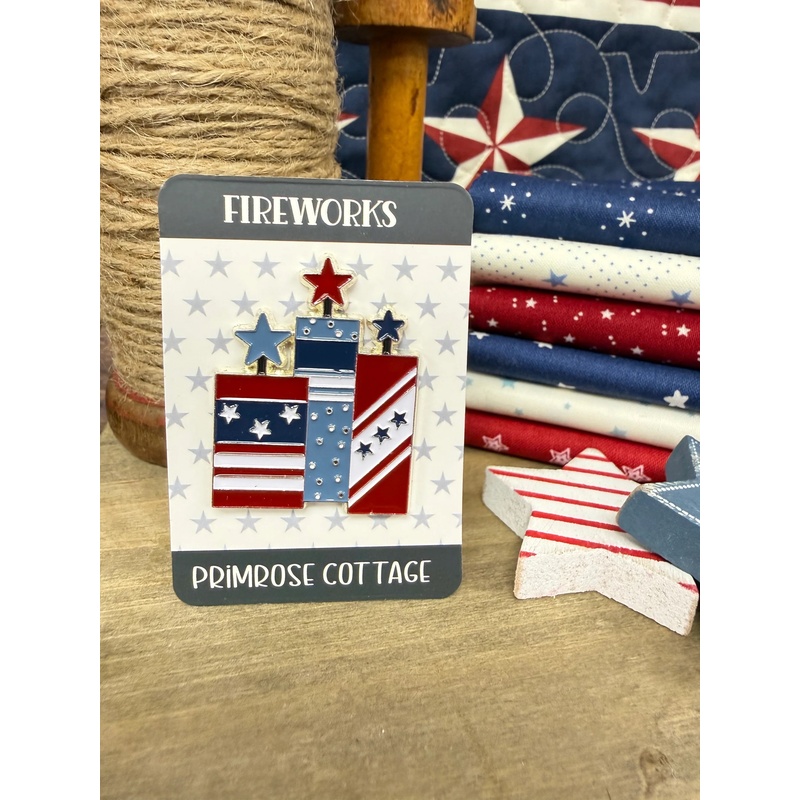 The Fireworks Magnetic Needle Minder with its paper packaging insert, staged with coordinating patriotic decor.