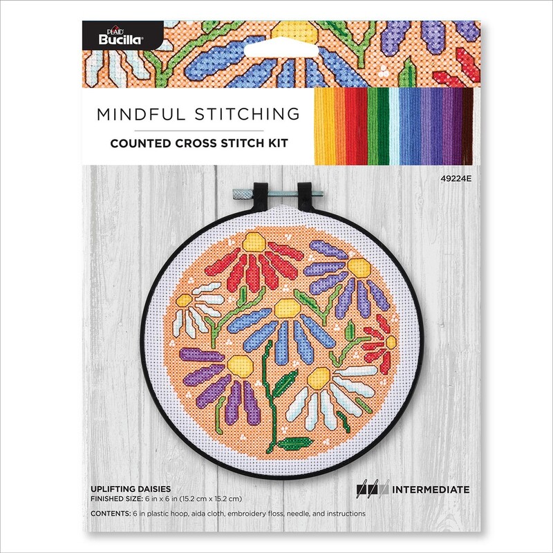 Counted cross stitch kit packaging featuring colorful daisies in a circular design and rainbow colors.