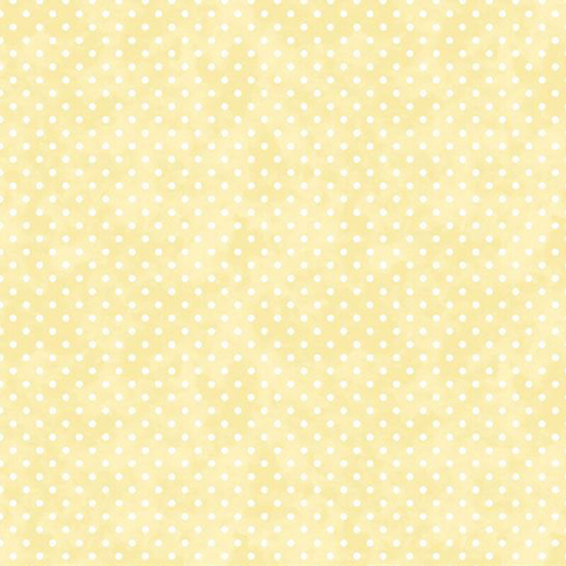White polka dots on top of a textured soft yellow fabric.