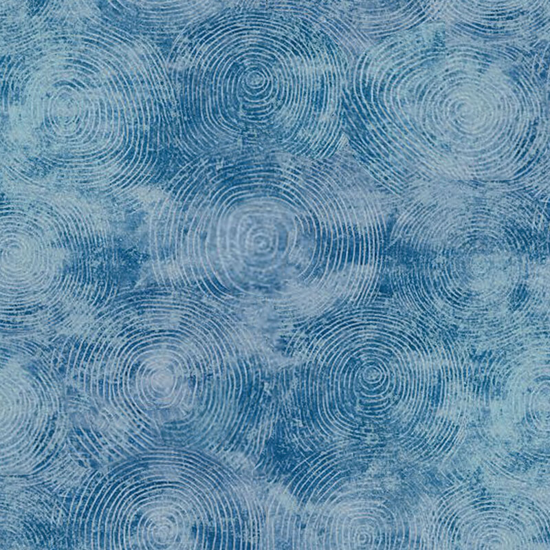Mottled blue fabric with a light swirl texture.
