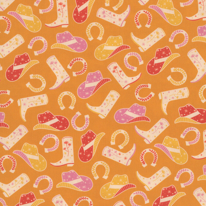A orange fabric featuring cowboy hats, boots, and horseshoes. 