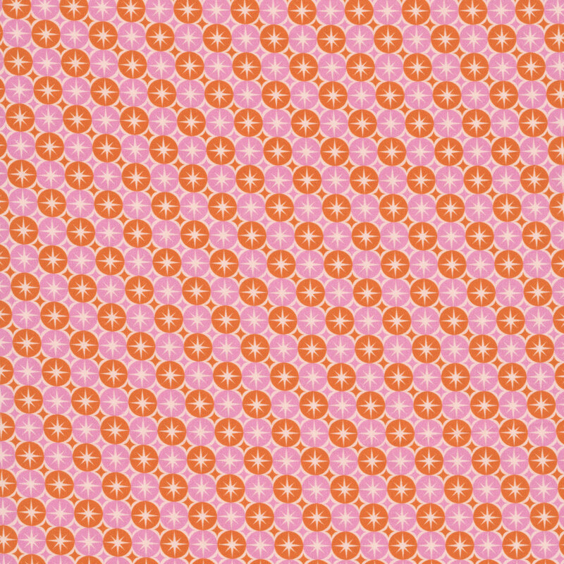 A multi-colored fabric featuring pink and orange circles and stars. 