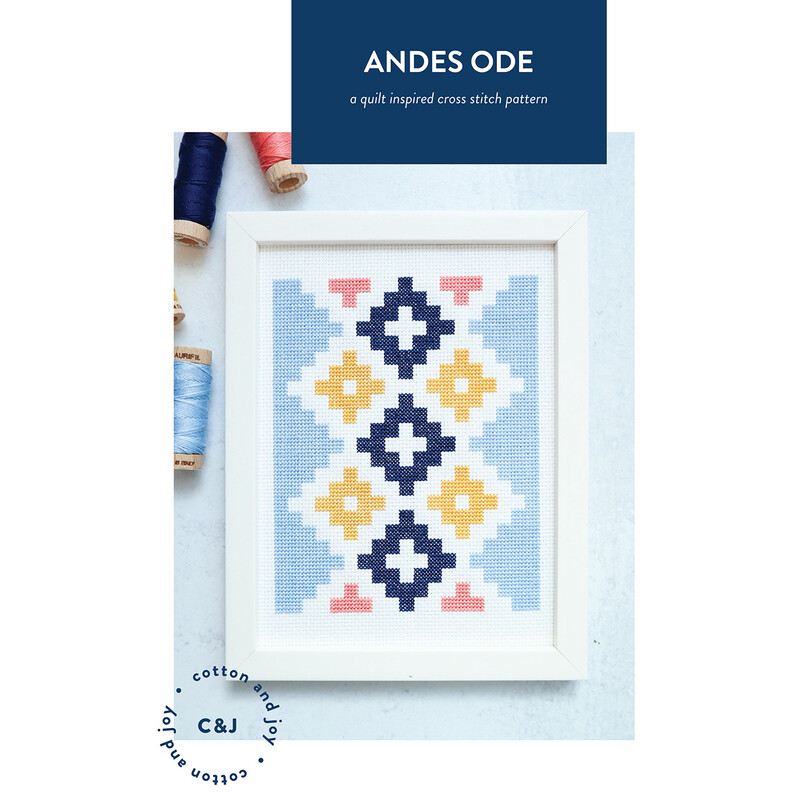 Framed cross-stitch design featuring geometric patterns in blue, yellow, pink, and navy.