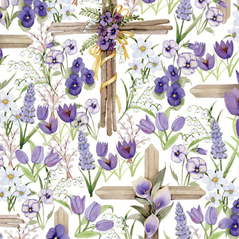 White fabric packed with a medley of purple florals and large wooden crosses draped with florals