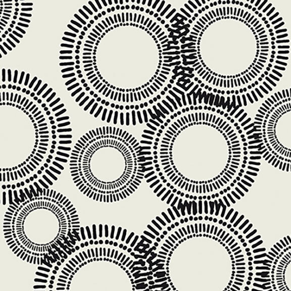 Blooming black circles of varying sizes scattered across an off-white fabric. 