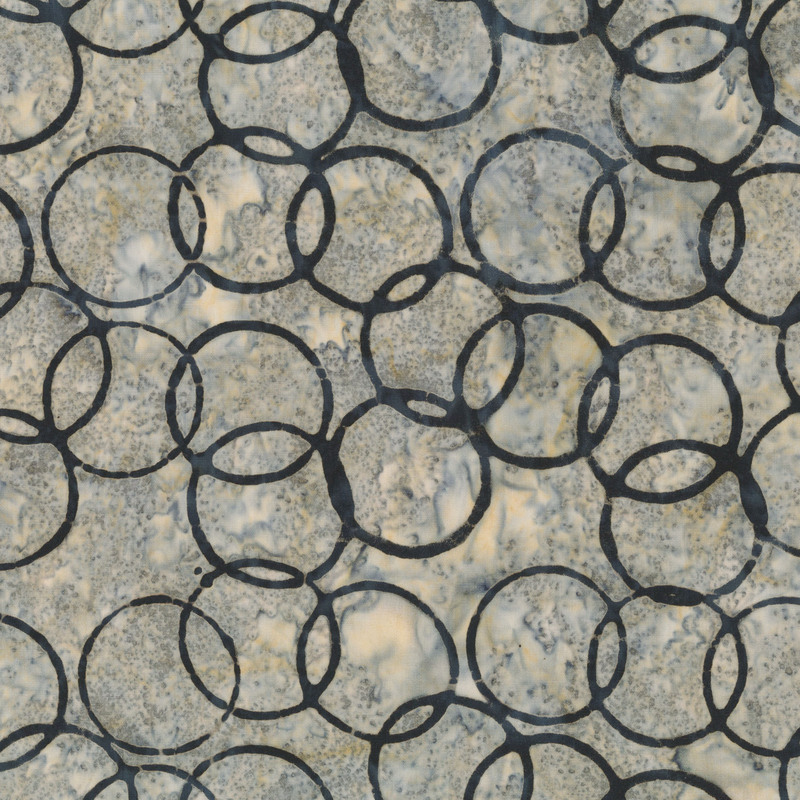 Greige batik with coal gray circles over the top.