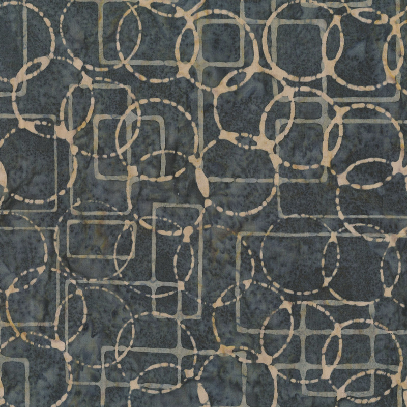 Slate gray batik with tan circles and rectangles over the top.
