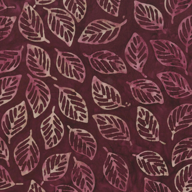 wine mottled fabric featuring a tropical leaf print in shades of blush and mauve
