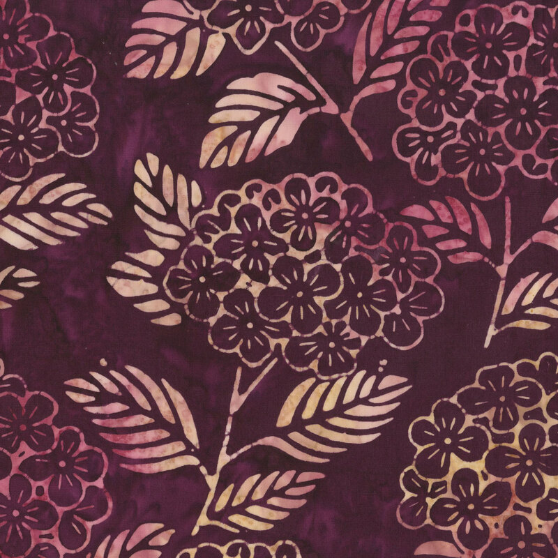 dark mulberry fabric with stylized florals and leaves in a mottled magenta red and pale yellow hues.