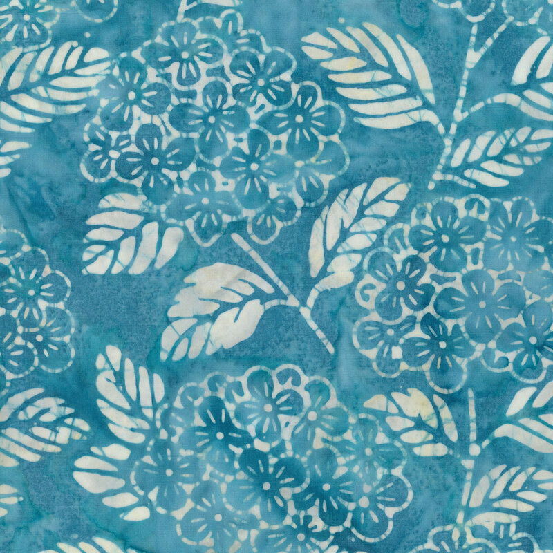 cerulean fabric with stylized florals and leaves in a mottled white and pale yellow hues