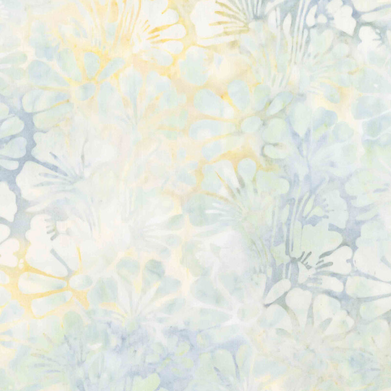 Light cadet blue, cream, and yellow batik overlayed with light teal florals.