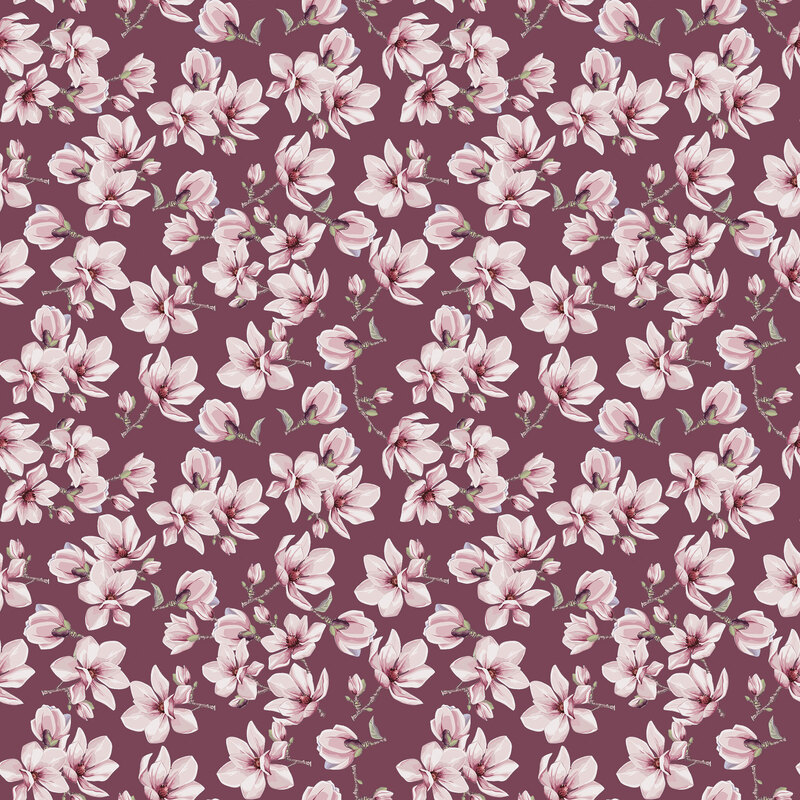 Burgundy fabric topped with sprigs of magnolias.