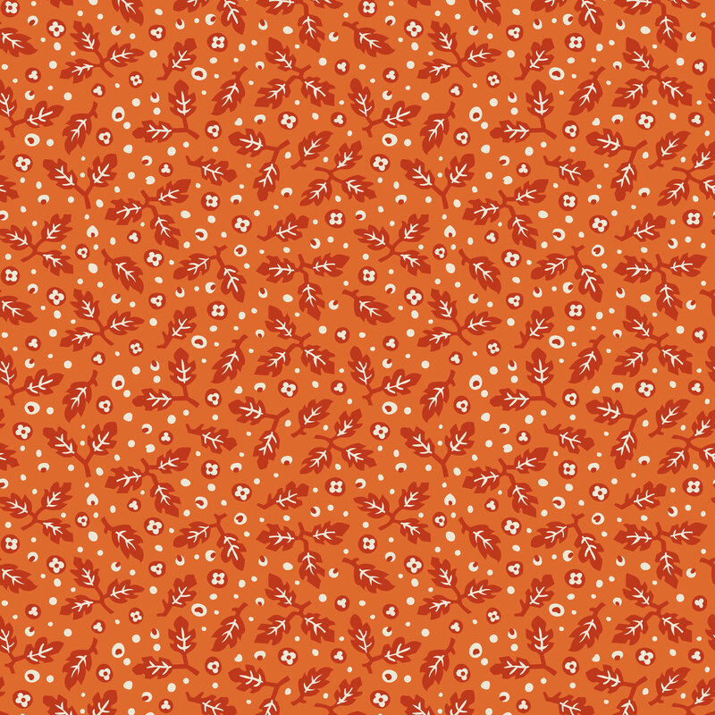 Pumpkin orange fabric of rusty red and white leaves and florals.
