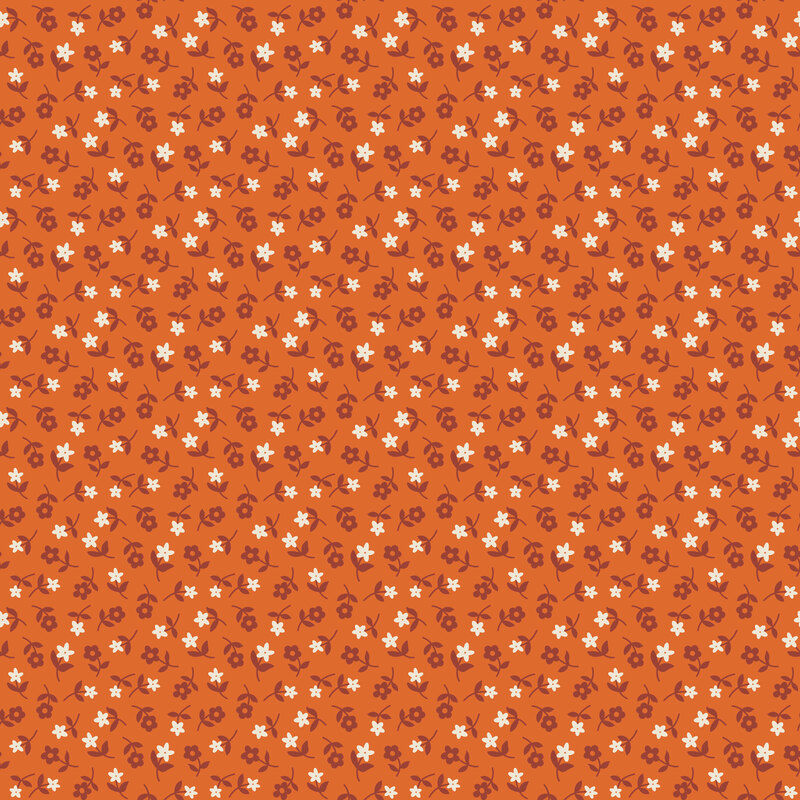 Pumpkin orange fabric tossed with rusty orange and white florals.