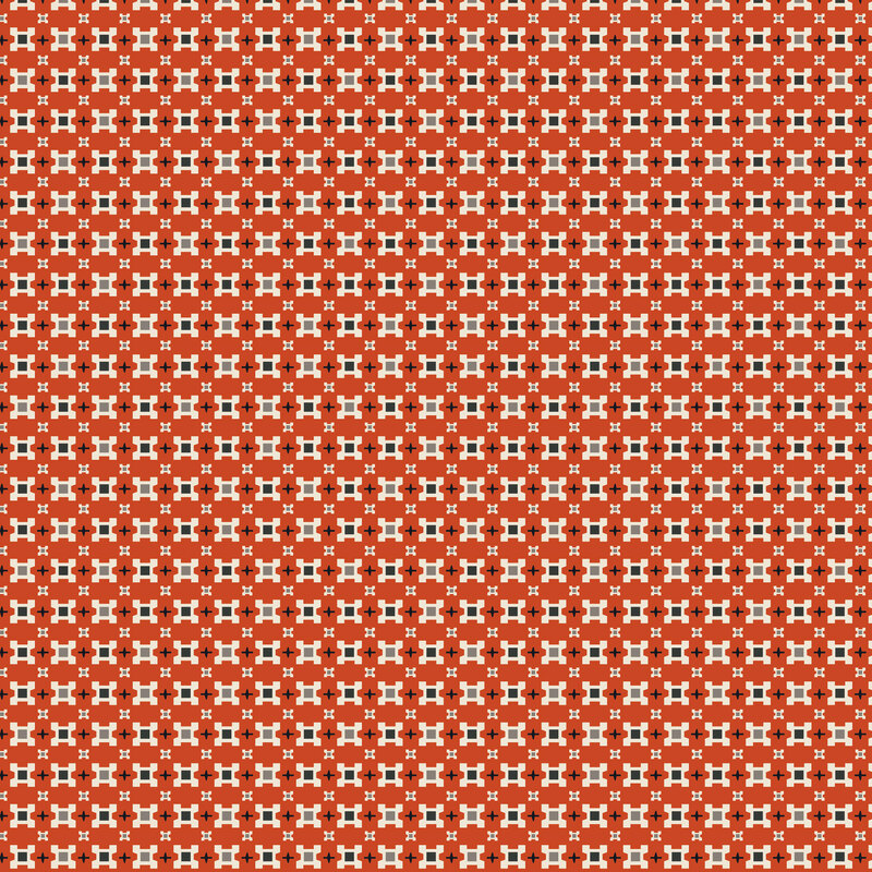 Rusty orange fabric topped with packed, tonal geometric florals separated by small crosses.