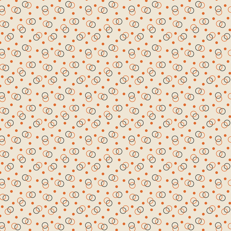 Cream fabric topped with orange and gray circles and dots.