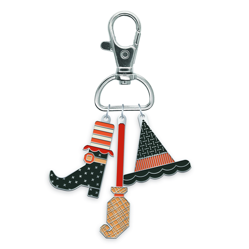 Pack of enamel charms, including a boot, a witch broom, and a witch hat.