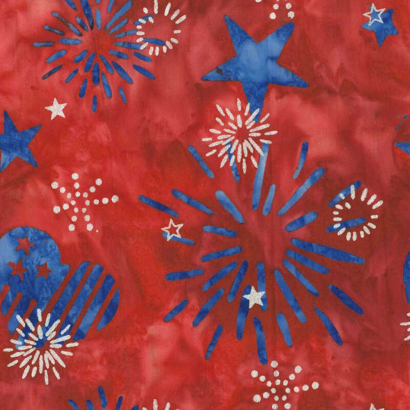 Scarlet red batik topped with blue stars, firework bursts, and hearts layered with silver metallics.