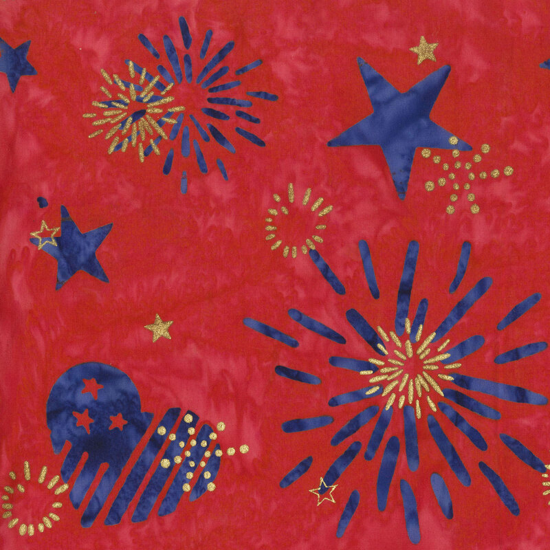 Soft red batik topped with blue stars, firework bursts, and hearts layered with gold metallics.
