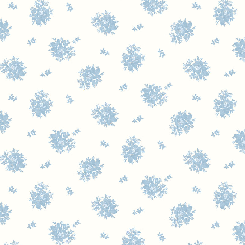 Cream fabric with a ditsy tossed pattern with two different designs of light blue florals.