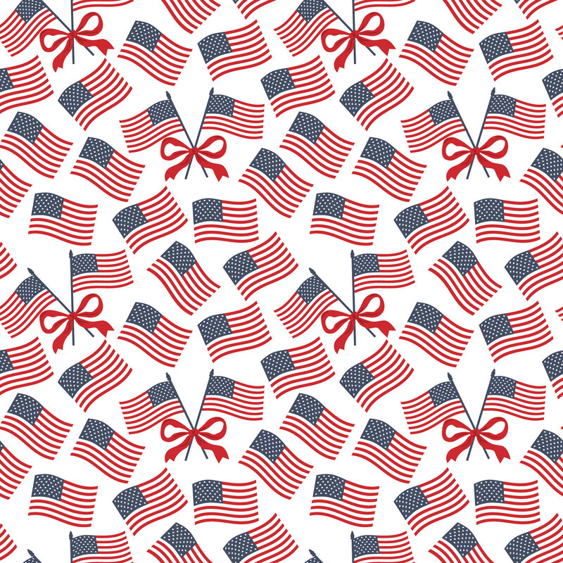 White fabric with tossed American flags and red bows.
