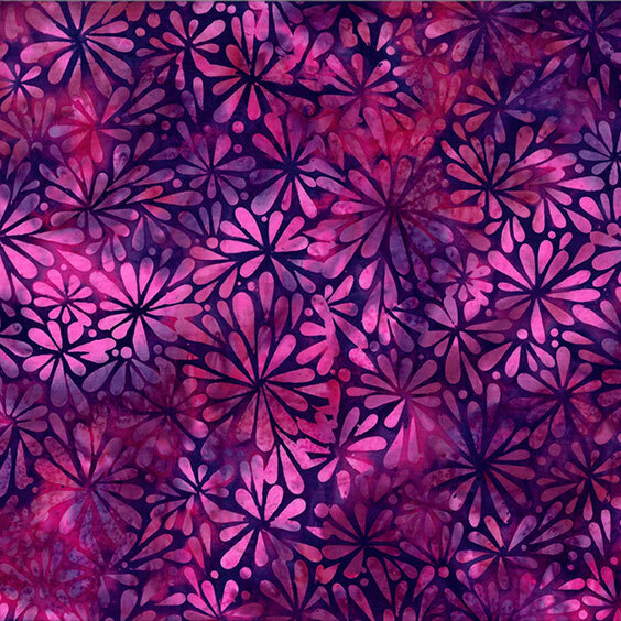 Rich purple and pink batik with a packed blooming flower motif design on top.
