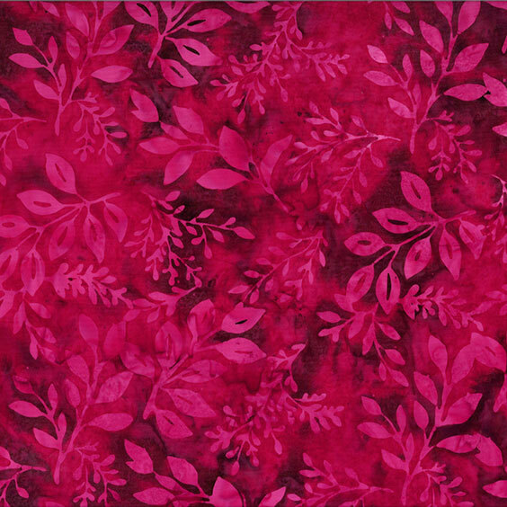 Red batik fabric with bright magenta leaf motifs across the top.