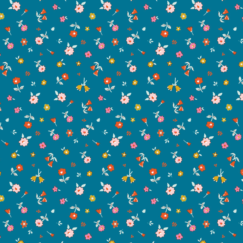An assortment of flowers tossed onto a denim blue fabric.