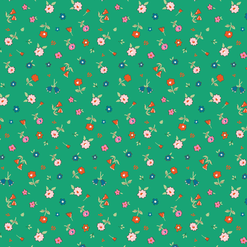 An assortment of flowers tossed onto a shamrock green fabric.