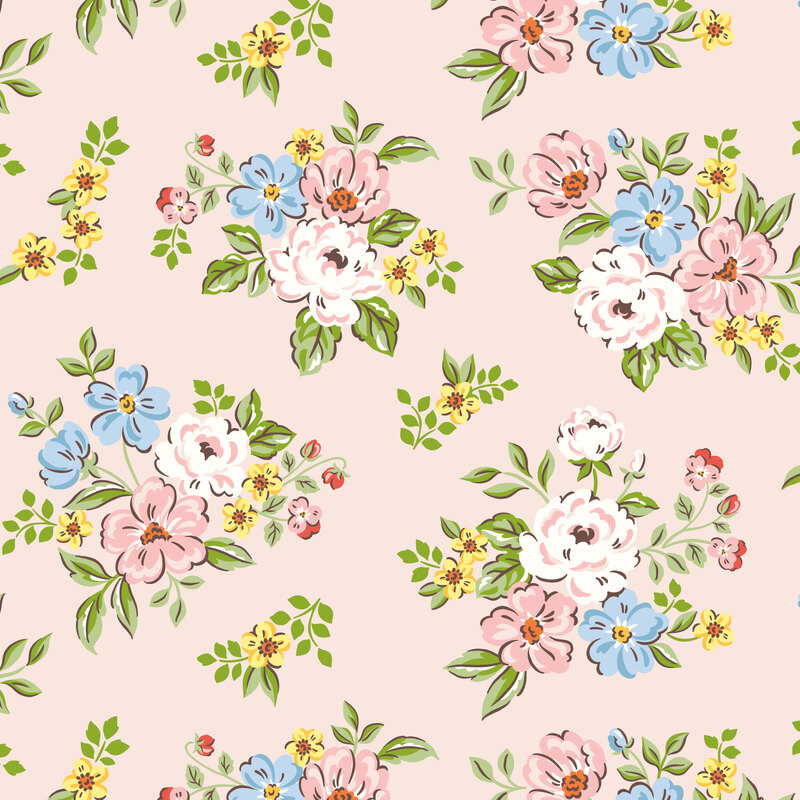 Pale pink fabric with tossed floral bouquets in hues of yellow, blue, pink, and white.