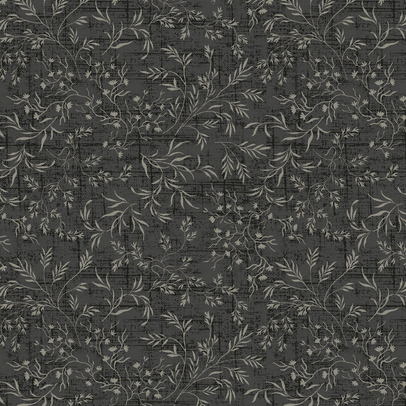 Black distressed tonal fabric with vines and leaves strewn over the top.