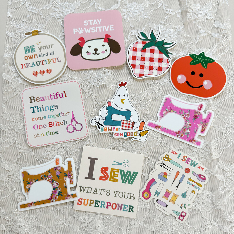 A collection of colorful sewing-themed stickers with positive messages, including a chicken, sewing machine, and fruits.