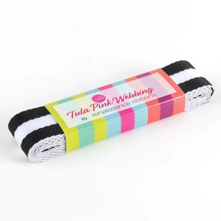Black and white striped webbing with a colorful label reading Tula Pink Webbing by Renaissance Ribbons.